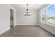 Bright dining room features hardwood floors, chandelier, and view to backyard at 6210 Misty Hill Ln, Buford, GA 30518