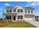 Charming two-story home with a manicured lawn, a brick facade, and a two-car garage at 6210 Misty Hill Ln, Buford, GA 30518