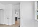 Hallway featuring hardwood floors that leads into an open kitchen with white cabinets at 6210 Misty Hill Ln, Buford, GA 30518