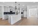 Bright kitchen features a spacious island, stainless appliances, and stylish cabinets against hardwood floors at 6210 Misty Hill Ln, Buford, GA 30518