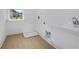 Clean and functional laundry room with a window and modern flooring at 6210 Misty Hill Ln, Buford, GA 30518