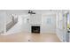 Bright living room with a fireplace, hardwood floors, and a staircase leading to the second floor at 6210 Misty Hill Ln, Buford, GA 30518