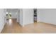Bright living room featuring hardwood floors, white walls, and natural light from the open entryway at 6210 Misty Hill Ln, Buford, GA 30518