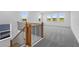 Spacious loft area featuring neutral carpet, bright windows, and staircase at 6210 Misty Hill Ln, Buford, GA 30518