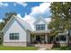 Two-story farmhouse with metal roof, white siding, and brick accents at 1440 Fairview Rd, Ellenwood, GA 30294