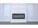 Modern electric fireplace with gray wall and white trim at 1440 Fairview Rd, Ellenwood, GA 30294