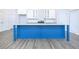 Modern kitchen with blue island, white cabinets, and granite countertops at 1440 Fairview Rd, Ellenwood, GA 30294