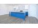 Modern kitchen with blue island, white cabinets, and granite countertops at 1440 Fairview Rd, Ellenwood, GA 30294