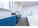 Modern kitchen with blue cabinets and granite countertops at 1440 Fairview Rd, Ellenwood, GA 30294