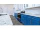Modern kitchen with blue cabinets and granite countertops at 1440 Fairview Rd, Ellenwood, GA 30294