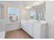Stylish bathroom with dual sinks, quartz counters, tub, tiled shower, and window views at 1920 Pearson St, Loganville, GA 30052
