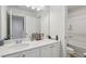 Bright bathroom featuring a white vanity with a quartz countertop and framed mirror at 1920 Pearson St, Loganville, GA 30052