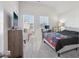 Bedroom featuring a fan, bed, dresser with a TV, and windows at 1920 Pearson St, Loganville, GA 30052