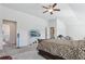 Bedroom with ceiling fan, TV on stand, bed and large carpeted area at 1920 Pearson St, Loganville, GA 30052