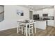 Eat-in kitchen area features white cabinets, stainless steel appliances, and a cozy dining table at 1920 Pearson St, Loganville, GA 30052