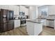 Beautiful kitchen with white cabinets, stainless steel appliances, granite countertops, and an island at 1920 Pearson St, Loganville, GA 30052