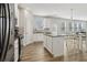 Bright eat-in kitchen featuring white cabinets, granite counters, stainless appliances, and hardwood floors at 1920 Pearson St, Loganville, GA 30052