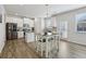 Bright kitchen with white cabinets, stainless steel appliances, kitchen island, and hardwood floors at 1920 Pearson St, Loganville, GA 30052