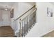 Elegant staircase with black metal balusters and wood handrail at 1920 Pearson St, Loganville, GA 30052