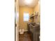 Laundry room with washer, dryer, shelving, and window at 2063 Emily Drive, Social Circle, GA 30025