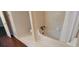 Bathroom featuring a toilet and bathtub with tile surround and shower curtain at 1294 Dogwood Rd, Snellville, GA 30078