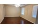 Spacious bedroom with hardwood floors, ceiling fan and natural light from two windows at 1294 Dogwood Rd, Snellville, GA 30078
