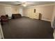 Large common area with carpeted floors and built-in shelving at 1294 Dogwood Rd, Snellville, GA 30078