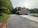 Asphalt driveway leading to brick home at 1294 Dogwood Rd, Snellville, GA 30078