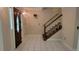 Entryway featuring tile flooring and wooden staircase with white risers at 1294 Dogwood Rd, Snellville, GA 30078
