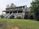 Brick house with large porch and landscaped lawn at 1294 Dogwood Rd, Snellville, GA 30078