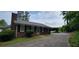 Exterior side view of brick home with black shutters, new roof, walkway, and manicured shrubs at 1294 Dogwood Rd, Snellville, GA 30078
