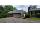 Attached two-car garage with brick siding, new roof, and a driveway for ample parking space at 1294 Dogwood Rd, Snellville, GA 30078