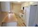 Kitchen with white cabinets, stainless steel sink, and white appliances at 1294 Dogwood Rd, Snellville, GA 30078