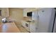Kitchen with white cabinets, stainless steel sink, and white appliances at 1294 Dogwood Rd, Snellville, GA 30078