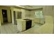 Open kitchen featuring tile countertops, white cabinetry, and stainless steel appliances at 1294 Dogwood Rd, Snellville, GA 30078