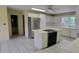 Bright kitchen with white cabinets, stainless steel appliances, and tiled countertops and flooring at 1294 Dogwood Rd, Snellville, GA 30078