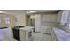 Bright kitchen with white cabinets, stainless steel appliances, and tiled countertops and flooring at 1294 Dogwood Rd, Snellville, GA 30078
