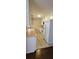 Kitchen with white cabinets and appliances and light pink countertops at 1294 Dogwood Rd, Snellville, GA 30078