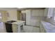 Bright kitchen with white cabinets, stainless steel appliances, and tiled countertops and flooring at 1294 Dogwood Rd, Snellville, GA 30078