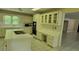 Open kitchen featuring tile countertops, white cabinetry, and stainless steel appliances at 1294 Dogwood Rd, Snellville, GA 30078