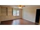 Living room with built-in shelves, cabinets and ceiling fan and hardwood floors at 1294 Dogwood Rd, Snellville, GA 30078