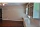 Living room with hardwood floors, built-in shelves, and neutral wall color at 1294 Dogwood Rd, Snellville, GA 30078
