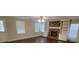 Spacious living room with hardwood floors, brick fireplace, and built-in shelving at 1294 Dogwood Rd, Snellville, GA 30078