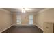 Cozy living room with plush carpet and natural light from shuttered windows at 1294 Dogwood Rd, Snellville, GA 30078