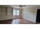 Living room with built-in shelves, cabinets and ceiling fan and hardwood floors at 1294 Dogwood Rd, Snellville, GA 30078