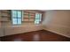 Living room with built-in shelves, drawers, and hardwood floors at 1294 Dogwood Rd, Snellville, GA 30078