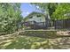 House with deck and fenced backyard, stone retaining wall, and lush green lawn at 2192 Spink St, Atlanta, GA 30318