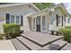 Inviting front porch with gray wooden steps and black door at 2192 Spink St, Atlanta, GA 30318