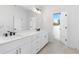 Bright bathroom featuring a double vanity with white cabinets and tile floors at 3076 Kelly St, Scottdale, GA 30079