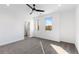 Light filled bedroom featuring neutral carpet, two windows, and a closet at 3076 Kelly St, Scottdale, GA 30079